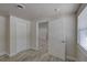 Bedroom with wood-look flooring, double closet and white trim, with an open door looking into the next room at 2608 Browning St, Sarasota, FL 34237