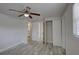 Bright bedroom featuring a ceiling fan, wood-look flooring, and an ensuite bathroom at 2608 Browning St, Sarasota, FL 34237