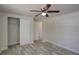 Bedroom features wood-look flooring, ceiling fan and closet at 2608 Browning St, Sarasota, FL 34237