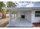 Attached carport with a door to the home and parking for two vehicles at 2608 Browning St, Sarasota, FL 34237