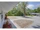 Front yard view of a home with mature trees and paved parking at 2608 Browning St, Sarasota, FL 34237