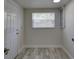 Hallway with a window, a door, and wood-look floors at 2608 Browning St, Sarasota, FL 34237