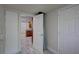 Hallway view with wood-look floors looking into a kitchen with wood cabinets at 2608 Browning St, Sarasota, FL 34237
