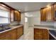 Beautiful kitchen featuring granite countertops and wooden cabinets with appliances and natural light at 2608 Browning St, Sarasota, FL 34237