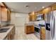A well-equipped kitchen featuring stainless steel appliances, granite countertops, and wooden cabinets at 2608 Browning St, Sarasota, FL 34237