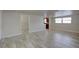 Bright living room with wood-look flooring, neutral paint, and ample natural light from windows at 2608 Browning St, Sarasota, FL 34237