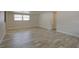 Open living room featuring wood-look flooring, neutral paint, and generous natural light at 2608 Browning St, Sarasota, FL 34237