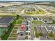 Aerial view showcasing the neighborhood and community amenities including ponds and green spaces at 2858 Star Anise Ln, Wimauma, FL 33598