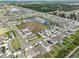 Aerial view of the neighborhood, showcasing the community layout, ponds, and surrounding greenery at 2858 Star Anise Ln, Wimauma, FL 33598