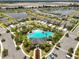 Aerial view showcasing the community pool, playground, clubhouse, and surrounding neighborhood at 2858 Star Anise Ln, Wimauma, FL 33598
