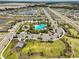 Community aerial view featuring a pool, playground, parks, and many single Gathering homes near a lake at 2858 Star Anise Ln, Wimauma, FL 33598