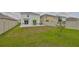 Large backyard features a patio, green grass, and is fully fenced for privacy at 2858 Star Anise Ln, Wimauma, FL 33598
