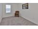 Cozy bedroom with a woven chair and natural light from the window that overlooks the street at 2858 Star Anise Ln, Wimauma, FL 33598