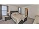 Comfortable bedroom with a queen bed, matching nightstands, lamps and ensuite bathroom access at 2858 Star Anise Ln, Wimauma, FL 33598