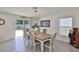 Cozy dining area featuring a chandelier and sliding doors to the backyard patio at 2858 Star Anise Ln, Wimauma, FL 33598