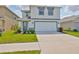 Charming two-story home with a well-maintained front yard and a two-car garage at 2858 Star Anise Ln, Wimauma, FL 33598