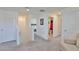 Bright hallway with carpeted floor, white walls and multiple doorways leading to bedrooms and bathrooms at 2858 Star Anise Ln, Wimauma, FL 33598