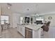 Open-concept kitchen with island seating flows into the living area, perfect for entertaining at 2858 Star Anise Ln, Wimauma, FL 33598