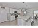 Bright kitchen with a large island, pendant lighting, and stainless steel appliances at 2858 Star Anise Ln, Wimauma, FL 33598