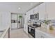 Well-equipped kitchen with stainless steel appliances, granite countertops, and ample cabinet space at 2858 Star Anise Ln, Wimauma, FL 33598