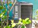Close-up of an Arctic Air Systems A/C unit surrounded by lush greenery at 3031 56Th S St, Gulfport, FL 33707