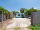 Charming light blue home with white trim, a manicured front yard, and tropical landscaping for curb appeal at 3031 56Th S St, Gulfport, FL 33707