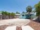 Charming light blue home with white trim, a manicured front yard, and tropical landscaping at 3031 56Th S St, Gulfport, FL 33707