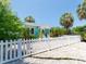 Charming home featuring a white picket fence, lovely landscaping, and inviting curb appeal at 3031 56Th S St, Gulfport, FL 33707