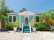 Charming cottage-style home features a quaint front porch, colorful exterior, and inviting landscaping at 3031 56Th S St, Gulfport, FL 33707