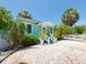 Charming light blue home with inviting front porch and white rock landscaping at 3031 56Th S St, Gulfport, FL 33707