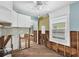 This kitchen is undergoing renovations but features white cabinets and a ceiling fan at 3031 56Th S St, Gulfport, FL 33707