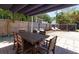 Backyard patio featuring a wooden dining table set on a brick paved patio, a shade structure, and a fenced yard at 3031 56Th S St, Gulfport, FL 33707