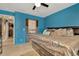 Bedroom with walk in closet, blue walls, and neutral flooring at 30703 San An Rd, San Antonio, FL 33576