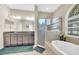Bathroom features double vanity, soaking tub under window, and glass enclosed shower at 311 Parsons Woods Dr, Seffner, FL 33584