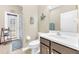 Bathroom featuring a toilet, white sink, and access to the outdoor patio at 311 Parsons Woods Dr, Seffner, FL 33584