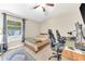 Bedroom displaying a bed, a window with blinds, and two computer gaming stations at 311 Parsons Woods Dr, Seffner, FL 33584