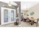 Elegant foyer with a view of the dining area, featuring tile floors and chandelier at 311 Parsons Woods Dr, Seffner, FL 33584