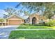 Charming single-story home with a well-manicured lawn and a two-car garage at 311 Parsons Woods Dr, Seffner, FL 33584