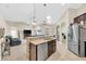 Open-concept kitchen features a central island with granite countertops and stainless steel appliances at 311 Parsons Woods Dr, Seffner, FL 33584