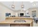 Close up of the kitchen island with stone accents and modern lighting at 311 Parsons Woods Dr, Seffner, FL 33584