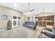 Spacious living room with tile flooring, ceiling fan, and french doors at 311 Parsons Woods Dr, Seffner, FL 33584
