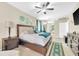 Main bedroom showcasing a large bed, ceiling fan, and access to an ensuite bathroom at 311 Parsons Woods Dr, Seffner, FL 33584