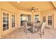 Covered patio features an outdoor dining set and access to the backyard and pool at 311 Parsons Woods Dr, Seffner, FL 33584
