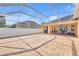 Spacious screened-in pool enclosure and patio with backyard view at 311 Parsons Woods Dr, Seffner, FL 33584
