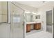 Bathroom with double sinks, a glass-enclosed shower, white tile floor, and great natural light at 31105 Whitlock Dr, Wesley Chapel, FL 33543
