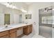 Bathroom features double sinks, large vanity area, walk-in closet, and framed mirror at 31105 Whitlock Dr, Wesley Chapel, FL 33543