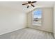 Bedroom featuring plush carpeting, a ceiling fan, and a large window that provides natural light at 31105 Whitlock Dr, Wesley Chapel, FL 33543