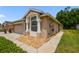Single-story home featuring an attached two-car garage and low-maintenance landscaping at 31105 Whitlock Dr, Wesley Chapel, FL 33543