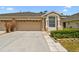 Charming single-story home featuring an attached two-car garage and well-maintained landscaping at 31105 Whitlock Dr, Wesley Chapel, FL 33543