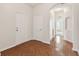 Bright foyer featuring wood floors, white walls, and an arched entryway at 31105 Whitlock Dr, Wesley Chapel, FL 33543